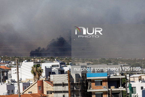 Smoke is being seen in the distance behind the inhabited area in Limassol, Cyprus, on May 31, 2024. Some buildings are being endangered afte...