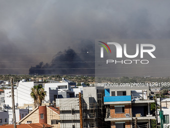 Smoke is being seen in the distance behind the inhabited area in Limassol, Cyprus, on May 31, 2024. Some buildings are being endangered afte...