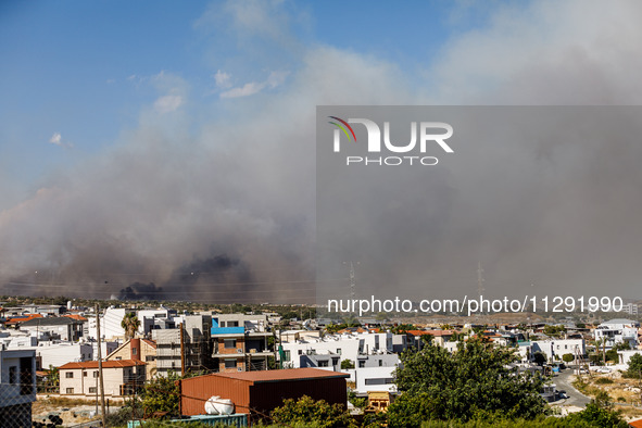 Smoke is being seen in the distance behind the inhabited area in Limassol, Cyprus, on May 31, 2024. Some buildings are being endangered afte...