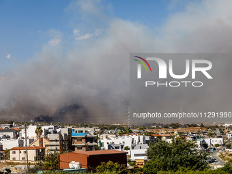 Smoke is being seen in the distance behind the inhabited area in Limassol, Cyprus, on May 31, 2024. Some buildings are being endangered afte...