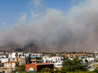 Smoke is being seen in the distance behind the inhabited area in Limassol, Cyprus, on May 31, 2024. Some buildings are being endangered afte...