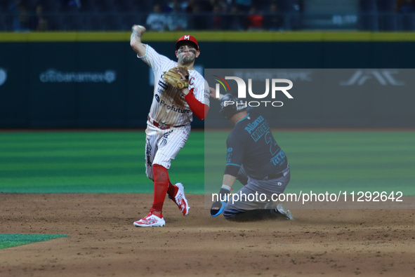 Second baseman Juan Carlos Gamboa #47 of Diablos Rojos is outing Diego Madero #2 of Saraperos de Saltillo during the Saraperos de Saltillo v...