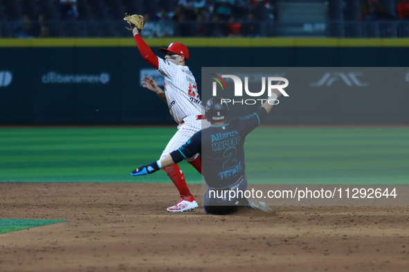 Second baseman Juan Carlos Gamboa #47 of Diablos Rojos is outing Diego Madero #2 of Saraperos de Saltillo during the Saraperos de Saltillo v...