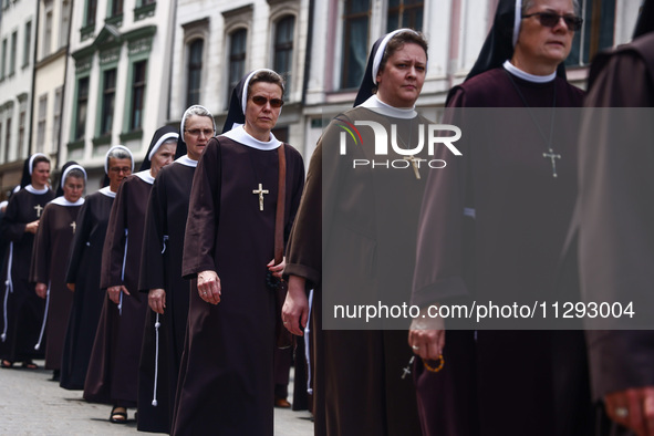 Nuns attend in Corpus Christi procession in Krakow, Poland on May 30, 2024. The procession starts with a priest carrying a monstrance under...