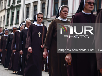 Nuns attend in Corpus Christi procession in Krakow, Poland on May 30, 2024. The procession starts with a priest carrying a monstrance under...