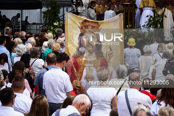 Faithfull attend Corpus Christi procession in Krakow, Poland on May 30, 2024. The procession starts with a priest carrying a monstrance unde...