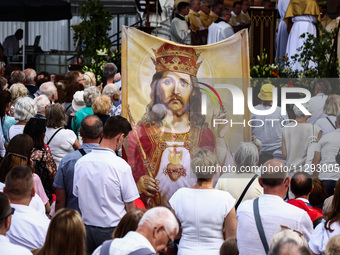 Faithfull attend Corpus Christi procession in Krakow, Poland on May 30, 2024. The procession starts with a priest carrying a monstrance unde...