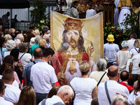 Faithfull attend Corpus Christi procession in Krakow, Poland on May 30, 2024. The procession starts with a priest carrying a monstrance unde...