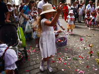 Children scatter flower petals during Corpus Christi procession in Krakow, Poland on May 30, 2024. The procession starts with a priest carry...