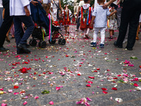 Children scatter flower petals during Corpus Christi procession in Krakow, Poland on May 30, 2024. The procession starts with a priest carry...