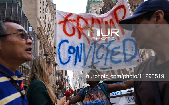 Anti-Trump protesters are standing outside as former president Donald Trump is making a statement after a guilty verdict at Trump Tower in N...