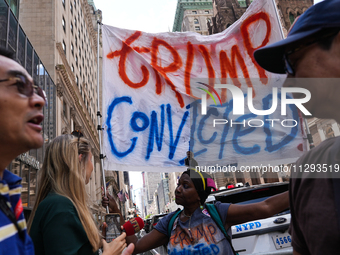 Anti-Trump protesters are standing outside as former president Donald Trump is making a statement after a guilty verdict at Trump Tower in N...