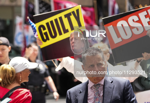 Anti-Trump protesters are standing outside as former president Donald Trump is making a statement after a guilty verdict at Trump Tower in N...