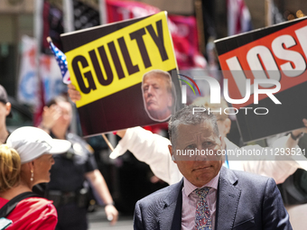 Anti-Trump protesters are standing outside as former president Donald Trump is making a statement after a guilty verdict at Trump Tower in N...