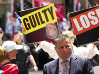 Anti-Trump protesters are standing outside as former president Donald Trump is making a statement after a guilty verdict at Trump Tower in N...