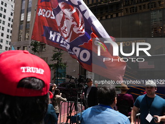 Trump supporters are standing outside as former president Donald Trump is making a statement after a guilty verdict at Trump Tower in New Yo...