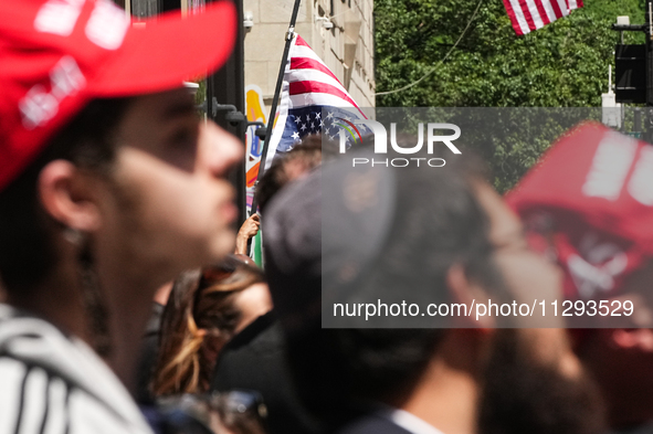 Trump supporters are standing outside as former president Donald Trump is making a statement after a guilty verdict at Trump Tower in New Yo...