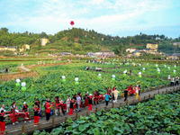 Tourists are visiting the ecological lotus pond in Huaying, China, on May 31, 2024. (