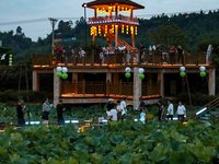 Tourists are visiting the ecological lotus pond in Huaying, China, on May 31, 2024. (