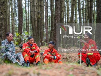 Forest rangers are resting on a forest patrol in Bijie, Guizhou province, China, on May 31, 2024. (