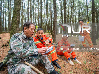 Forest rangers are resting on a forest patrol in Bijie, Guizhou province, China, on May 31, 2024. (