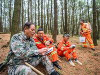 Forest rangers are resting on a forest patrol in Bijie, Guizhou province, China, on May 31, 2024. (