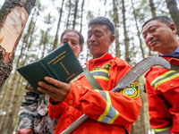 Forest rangers are registering their patrol in Bijie, Guizhou province, China, on May 31, 2024. (