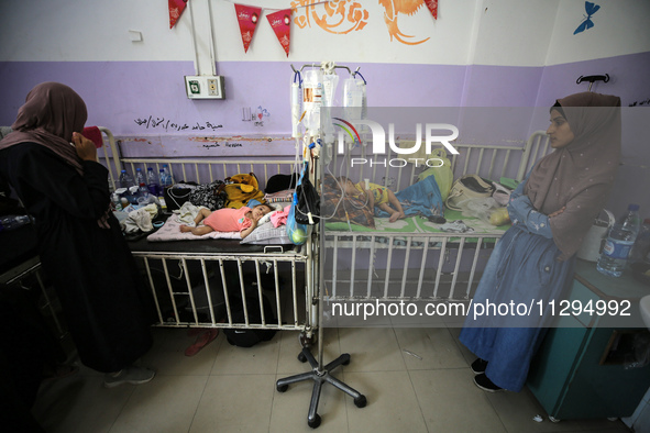 Palestinian women are accompanying children in need of treatment for malnourishment at Al-Aqsa Martyrs Hospital in Deir al-Balah in the cent...