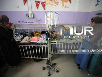 Palestinian women are accompanying children in need of treatment for malnourishment at Al-Aqsa Martyrs Hospital in Deir al-Balah in the cent...