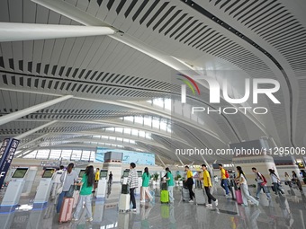 Simulated passengers are entering the departure hall of T2 Terminal of Yantai Penglai International Airport in Yantai, China, on June 1, 202...