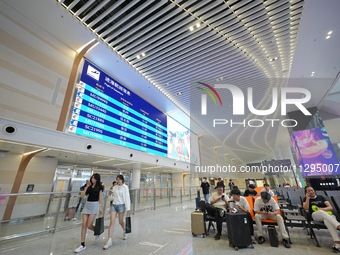 Simulated passengers are resting at the assembly point in the arrival hall of T2 Terminal of Yantai Penglai International Airport in Yantai,...