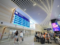 Simulated passengers are resting at the assembly point in the arrival hall of T2 Terminal of Yantai Penglai International Airport in Yantai,...