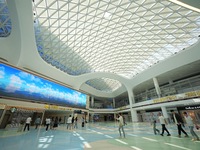 Simulated passengers are passing through the atrium of the T2 terminal of Yantai Penglai International Airport in Yantai, China, on June 1,...