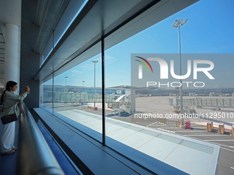 Simulated passengers are taking photos of the tarmac at the T2 terminal of Yantai Penglai International Airport in Yantai, China, on June 1,...