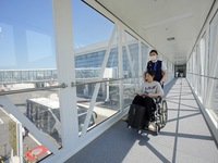 A staff member is helping a ''special passenger'' board a plane at the T2 terminal of Yantai Penglai International Airport in Yantai, China,...