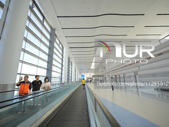 Simulated passengers are making their way to the boarding gate at the T2 terminal of Yantai Penglai International Airport in Yantai, China,...