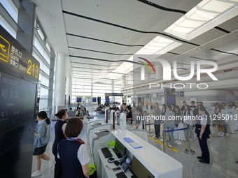 Simulated passengers are boarding a plane at the T2 terminal of Yantai Penglai International Airport in Yantai, China, on June 1, 2024. (