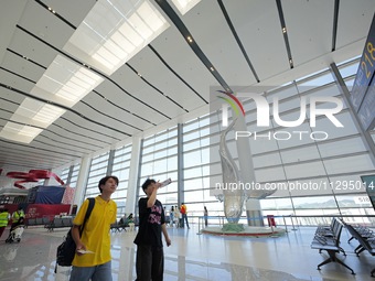 Simulated passengers are making their way to the boarding gate at the T2 terminal of Yantai Penglai International Airport in Yantai, China,...