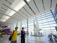 Simulated passengers are making their way to the boarding gate at the T2 terminal of Yantai Penglai International Airport in Yantai, China,...