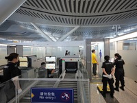 Simulated passengers are passing through the millimeter-wave security gate at the T2 terminal of Yantai Penglai International Airport in Yan...