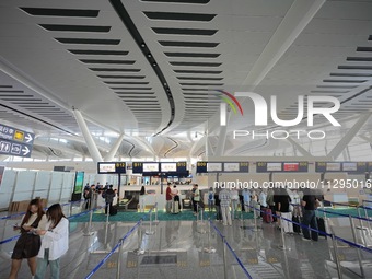 Simulated passengers are checking in their luggage at the T2 terminal of Yantai Penglai International Airport in Yantai, China, on June 1, 2...