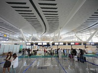 Simulated passengers are checking in their luggage at the T2 terminal of Yantai Penglai International Airport in Yantai, China, on June 1, 2...