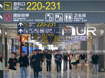 Simulated passengers are making their way to the boarding gate at the T2 terminal of Yantai Penglai International Airport in Yantai, China,...