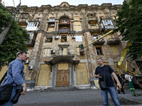 Municipal workers are dealing with the consequences of the Russian missile attack in Zaporizhzhia, southeastern Ukraine, on June 1, 2024. In...