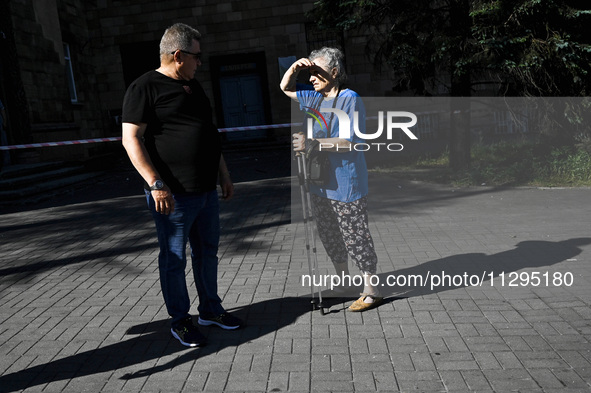 A man and woman are standing in the street after the Russian missile attack in Zaporizhzhia, southeastern Ukraine, on June 1, 2024. In Zapor...