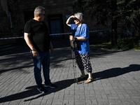 A man and woman are standing in the street after the Russian missile attack in Zaporizhzhia, southeastern Ukraine, on June 1, 2024. In Zapor...