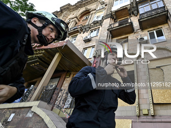 Rescuers are seen outside a residential building after the Russian missile attack in Zaporizhzhia, Ukraine, on June 1, 2024. In Zaporizhzhia...