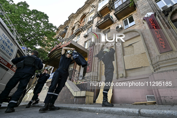 Rescuers are seen outside a residential building after the Russian missile attack in Zaporizhzhia, Ukraine, on June 1, 2024. In Zaporizhzhia...