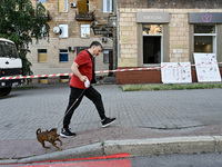 A man is walking a dog past a residential building damaged by the Russian missile attack in Zaporizhzhia, Ukraine, on June 1, 2024. In Zapor...