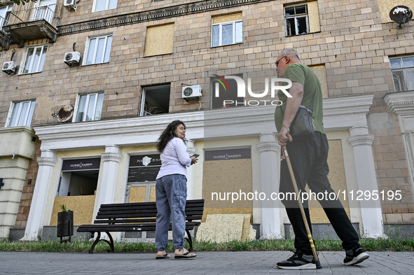 People are staying outside a residential building after the Russian missile attack in Zaporizhzhia, Ukraine, on June 1, 2024. In Zaporizhzhi...